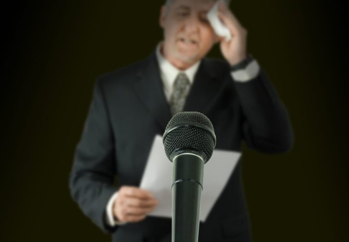 Man at Microphone with a Fear of Public Speaking
